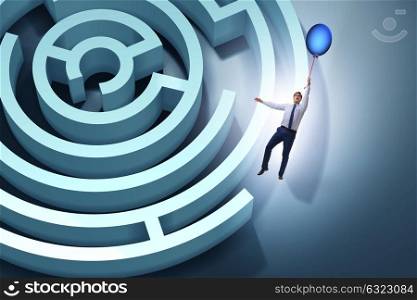 Businessman escaping from maze on balloon