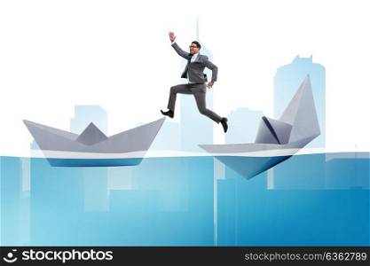 Businessman escaping sunken paper boat ship