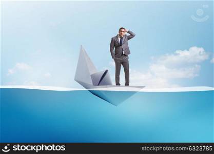 Businessman escaping sunken paper boat ship. The businessman escaping sunken paper boat ship