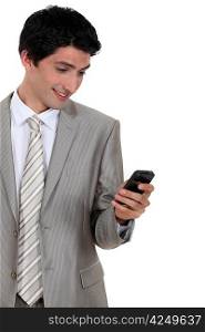 Businessman excited by text message in mobile