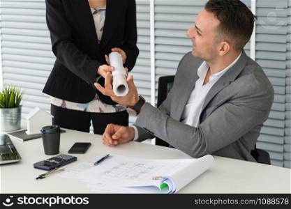 Businessman executive checking work while meeting discussion with businesswoman worker in modern workplace office. People corporate business team concept.