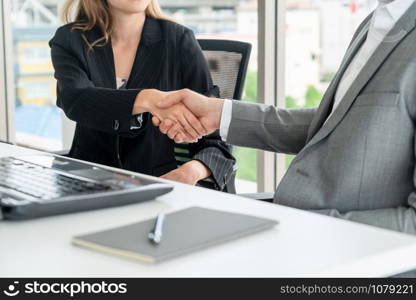 Businessman executive handshake with businesswoman worker in modern workplace office. People corporate business deals concept.