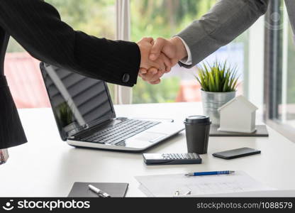 Businessman executive handshake with businesswoman worker in modern workplace office. People corporate business deals concept.