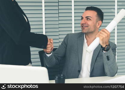 Businessman executive handshake with businesswoman worker in modern workplace office. People corporate business deals concept.