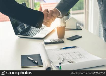 Businessman executive handshake with businesswoman worker in modern workplace office. People corporate business deals concept.
