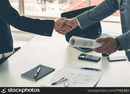 Businessman executive handshake with businesswoman worker in modern workplace office. People corporate business deals concept.
