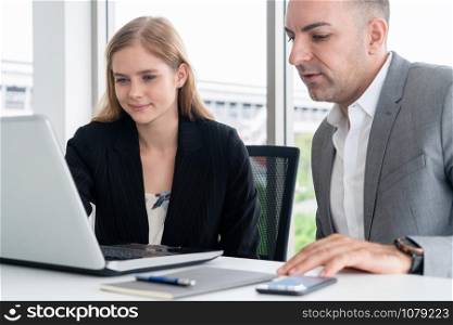 Businessman executive is in meeting discussion with a businesswoman worker in modern workplace office. People corporate business team concept.