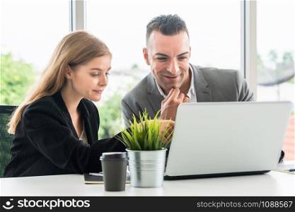 Businessman executive is in meeting discussion with a businesswoman worker in modern workplace office. People corporate business team concept.