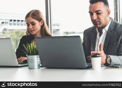 Businessman executive is in meeting discussion with a businesswoman worker in modern workplace office. People corporate business team concept.