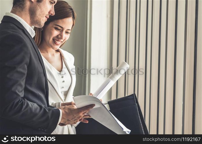 Businessman executive is in meeting discussion with businesswoman or client in modern workplace office. People corporate business team concept.