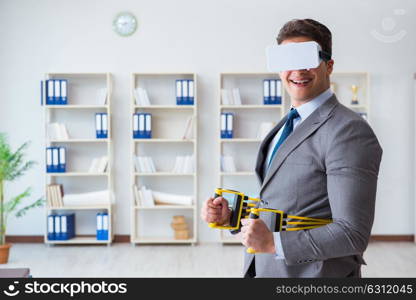 Businessman exercising with elastic expander wearing VR glasses. The businessman exercising with elastic expander wearing vr glasses