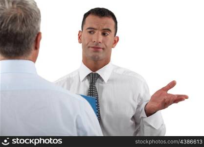 Businessman explaining point to colleague