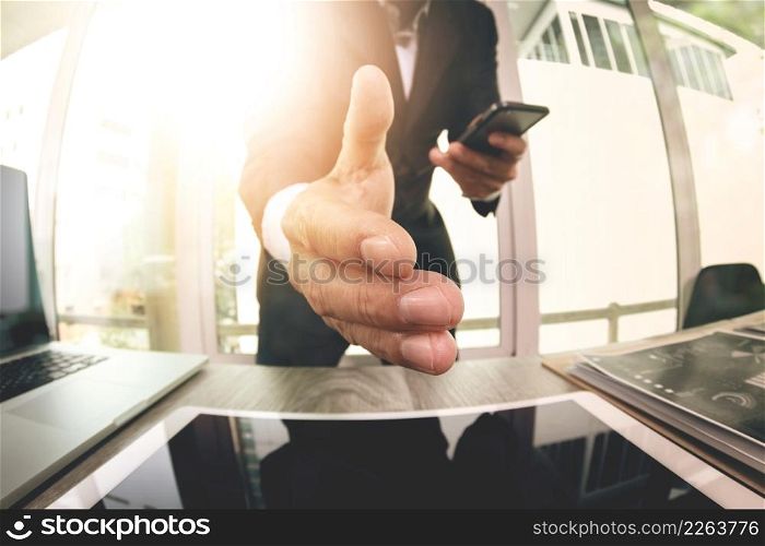businessman extending hand to shake with digital business strategy diagram in his office as concept