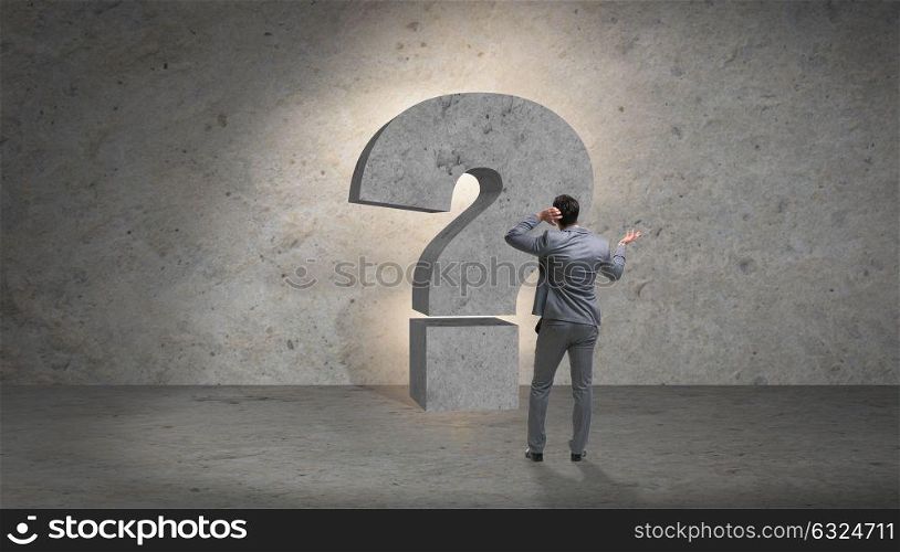Businessman facing questions in business