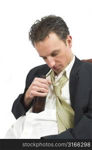 Businessman falling asleep with his beer bottle this in his hand