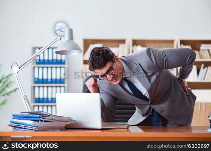 Businessman feeling pain in the office