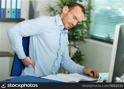 businessman feeling pain in the office