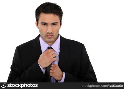 Businessman fixing his tie