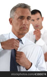 Businessman fixing his tie