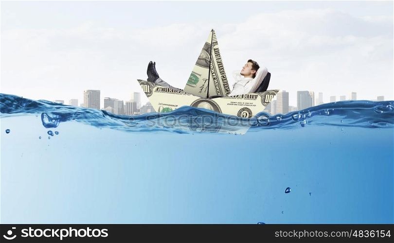Businessman floating in paper ship. Concept of fake threat when businessman float in paper ship