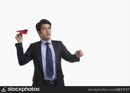 Businessman flying a paper plane