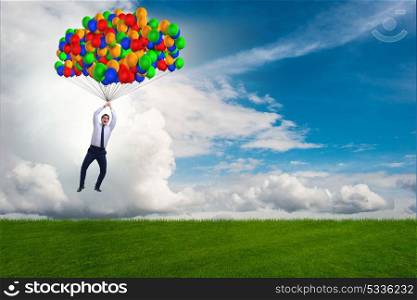 Businessman flying balloons on bright day