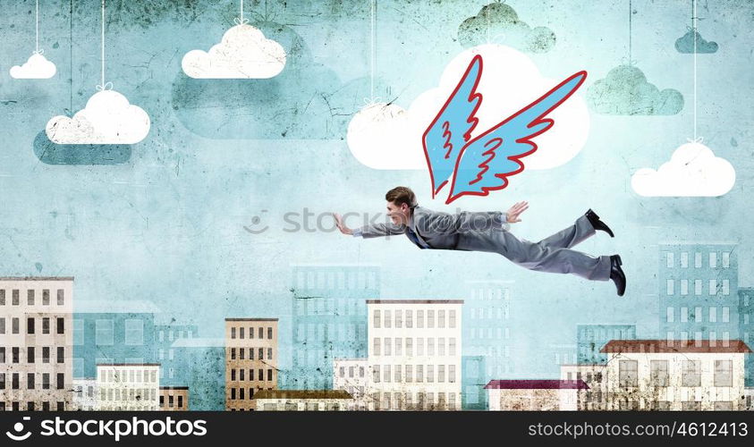 Businessman flying high. Young businessman with drawn wings flying in sky