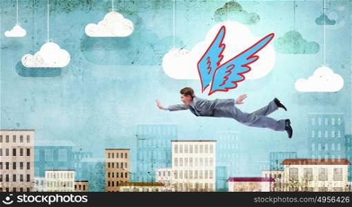 Businessman flying high. Young businessman with drawn wings flying in sky