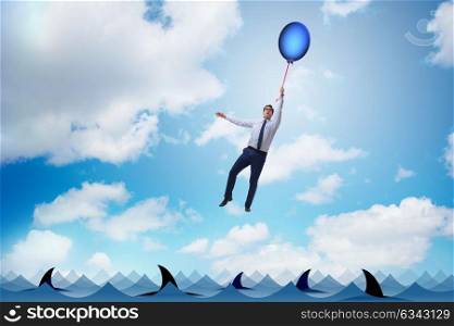 Businessman flying holding balloon