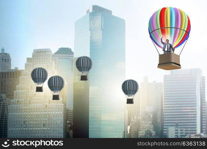 Businessman flying on balloon in challenge concept