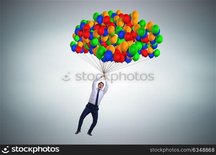 Businessman flying on balloons in challenge concept