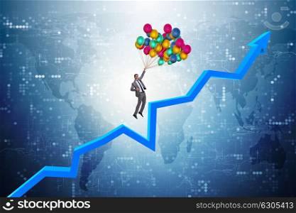 Businessman flying on balloons over graph