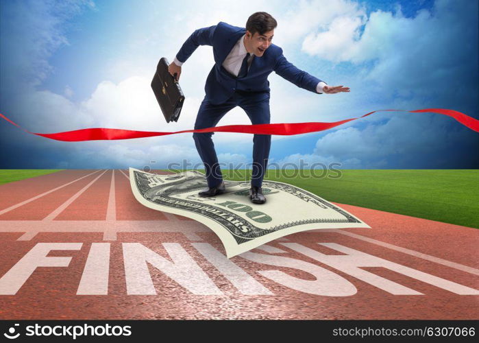 Businessman flying on dollar banknote towards finish line