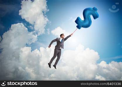 Businessman flying on dollar sign inflatable balloon