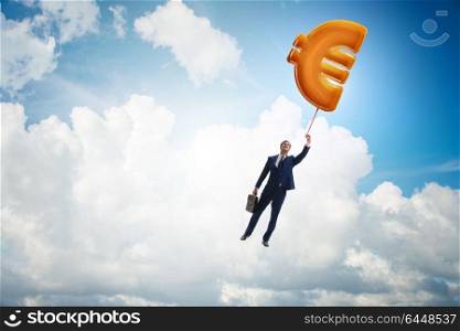 Businessman flying on euro sign inflatable balloon