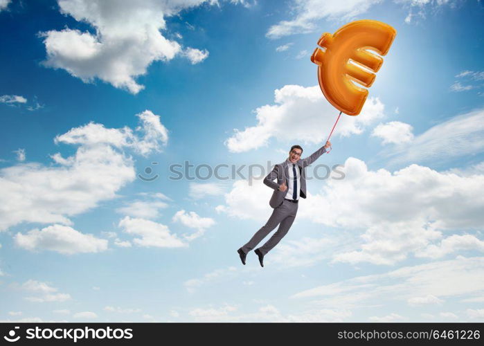 Businessman flying on euro sign inflatable balloon