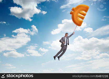 Businessman flying on euro sign inflatable balloon