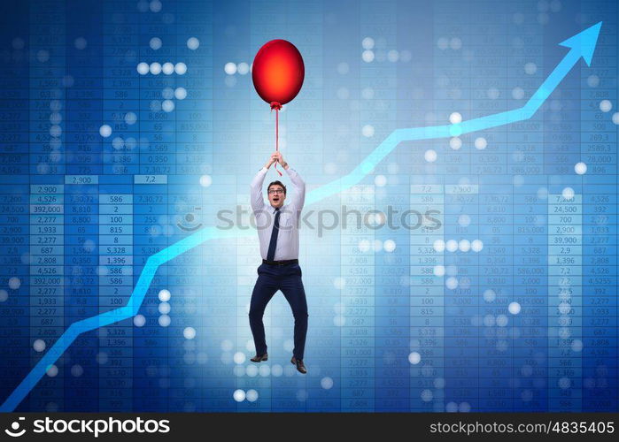 Businessman flying on hot balloon over graph