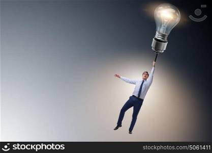 Businessman flying on lamp balloon