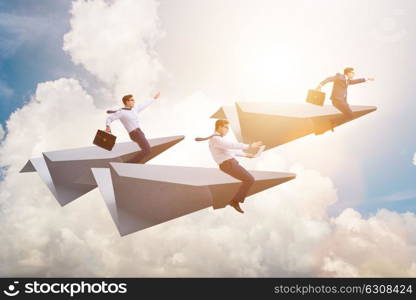 Businessman flying on paper plane in business concept. The businessman flying on paper plane in business concept