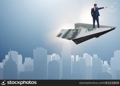 Businessman flying on paper plane in business concept