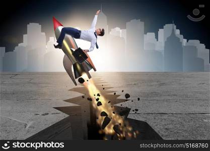 Businessman flying on rocket from rock gap. The businessman flying on rocket from rock gap