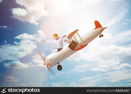 Businessman flying on vintage old airplane