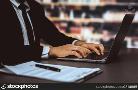 Businessman focused on his laptop working on financial report or planning business strategy in library. Modern office worker utilizing technology in the field of business. Equilibrium. Businessman focused on his laptop working on financial report. Equilibrium