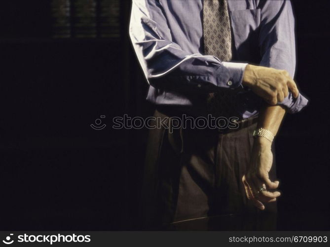 Businessman folding up his sleeves