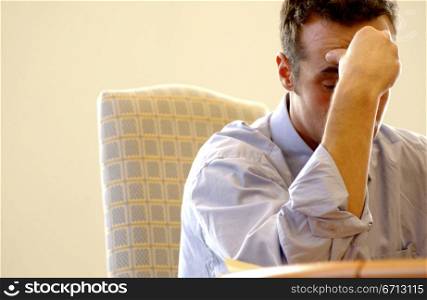 businessman frustrated at table