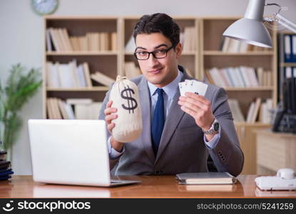 Businessman gambling playing cards at work