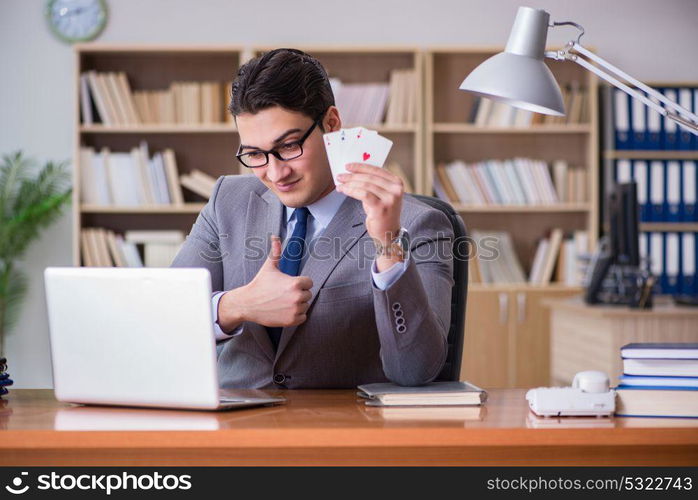 Businessman gambling playing cards at work