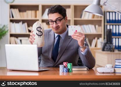 Businessman gambling playing cards at work