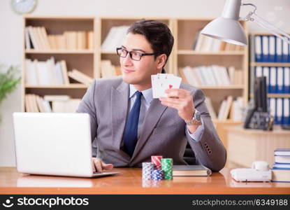 Businessman gambling playing cards at work